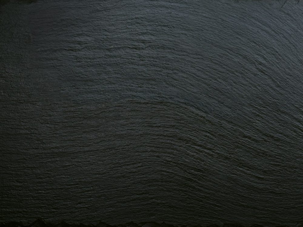 Black slate texture background, ceramic kitchen dish, restaurant menu backdrop